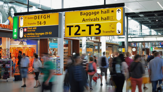 people traveling busy airport