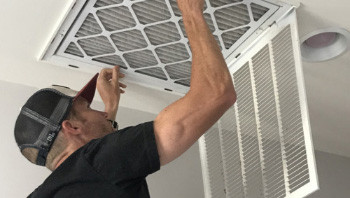 Man replacing air filter